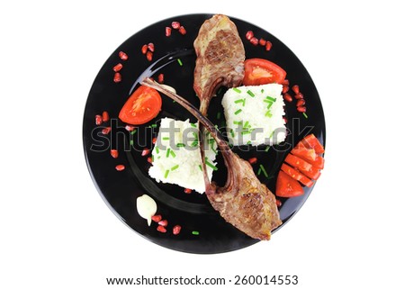 meat savory: roast veal ribs with rice garnish and pomegranate seeds over white background