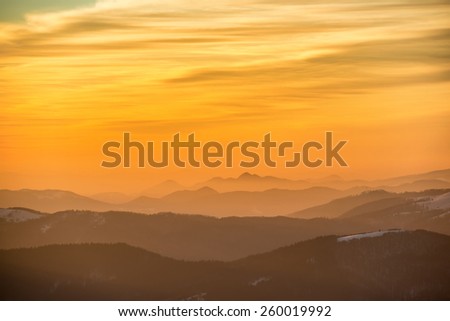 Sunset in winter mountains covered with snow. 