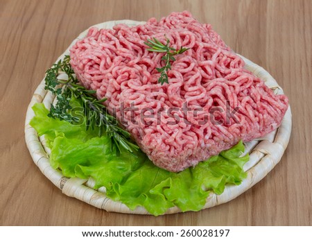 Raw minced meat with rosemary and thyme ready for cooking