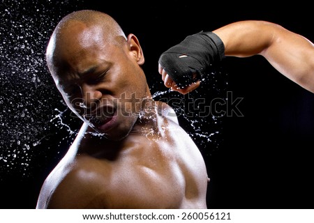 mma fighter or boxer losing and getting hit in the face Royalty-Free Stock Photo #260056121