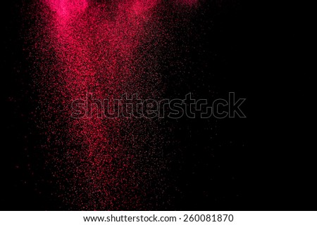  Abstract red and pink powder explosion on black background.
