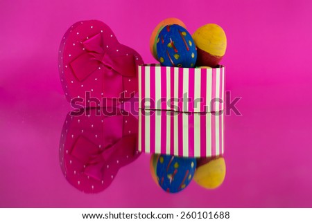 Egg Easter in heart box with a pink background.