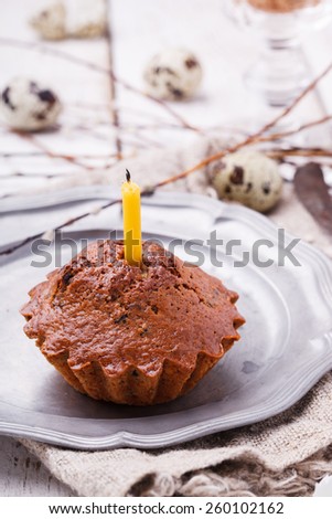 Cupcake with a candle, quail eggs decorating willow.selective focus