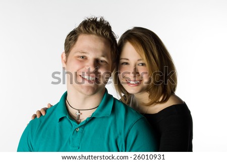 Man and woman sitting together smiling on a white background