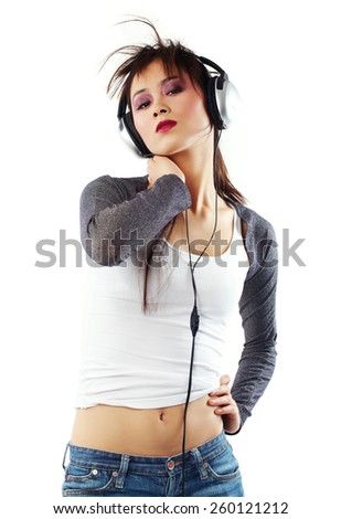 Young Asian woman with headphones posing on white background.