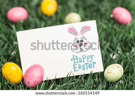 easter bunny with greeting against blank greeting card with easter eggs