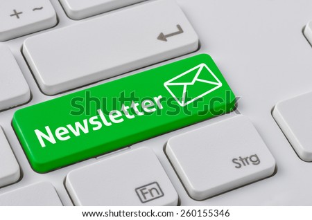 A keyboard with a green button - Newsletter
