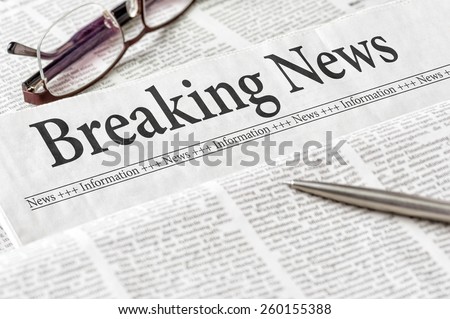 A newspaper with the headline Breaking News Royalty-Free Stock Photo #260155388
