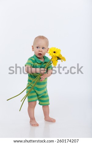 Little boy with yellow flowers