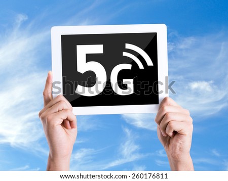 Tablet pc with text 5G with sky background