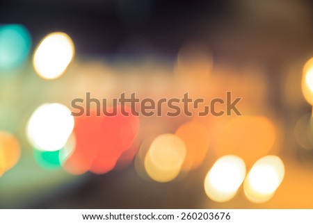 Abstract background of bokeh light at city night with vintage color tone tuned 