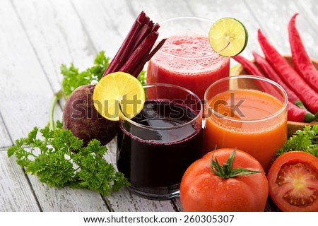 portrait of glasses with vegetable juices. beetroot juice, tomato juice, chili juice Royalty-Free Stock Photo #260305307