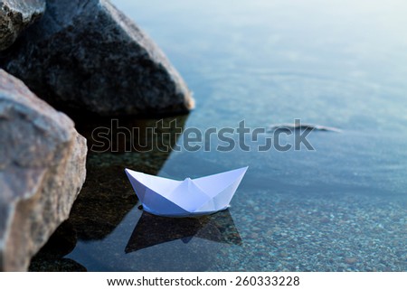 paper boat floating in the water
