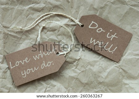 Two Beige Labels Or Tags With White Ribbon On Crumpled Paper Background With English Life Quote Love What You Do Do It Well Vintage Or Retro Style