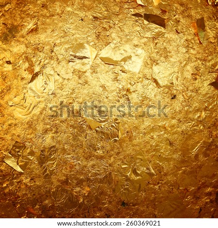 Old gold grunge wall with peeling paint with old concrete Royalty-Free Stock Photo #260369021
