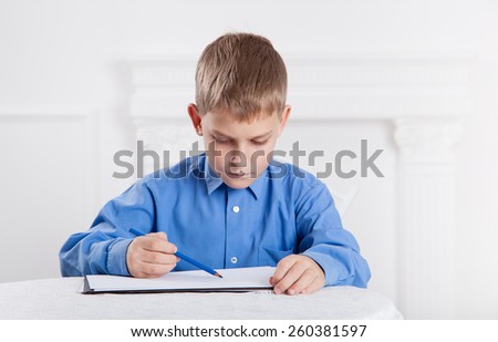  boy draws a pencil on the album