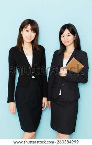 portrait of asian businesswomen on blue background