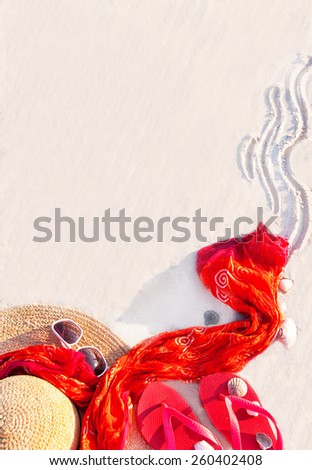 Sand texture (background) with flip flop sandals, hat, pareos (sarong), sunglasses, shellfishes (scallop) on the beach. The empty pattern for message. Summer vacations (travel) concept. Copy space.