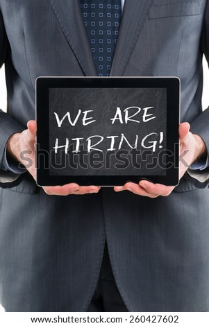We Are Hiring! Businessman holding digital tablet pc with chalkboard screen