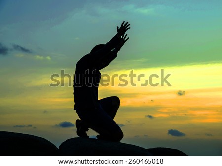 praying man on beautiful sky background Royalty-Free Stock Photo #260465018