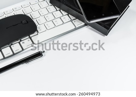 Notepad, keyboard, mouse and cell phone on white background