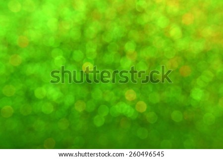 Bright and abstract blurred green background with shimmering glitter