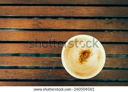 Top view of coffee cup on wooden table - vintage effect style pictures