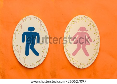 A man and lady toilet sign on orange background