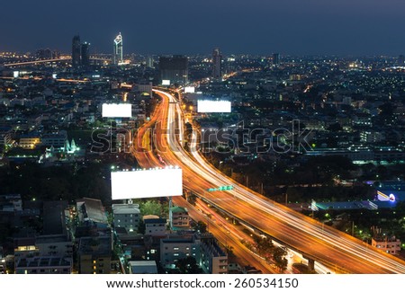 Big blank billboard with expressway and cityscape at twilight time