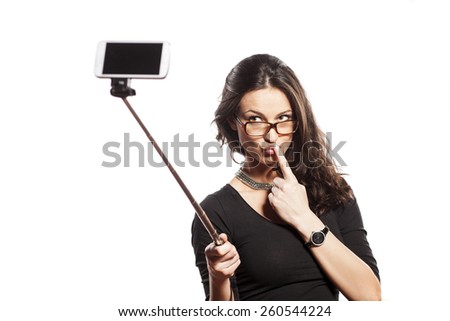 pretty brunette making selfie with a stick