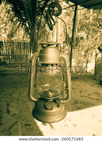 Old kerosene lantern burning with bright flame