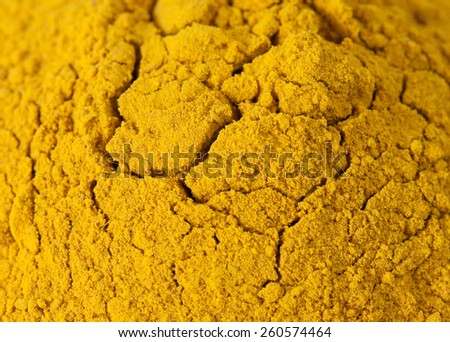 Picture of vivid dark yellow curry powder spice exotic seasoning with fractal cracks
