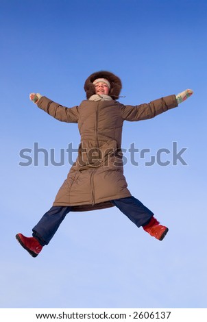 happy jumping girl at winter time