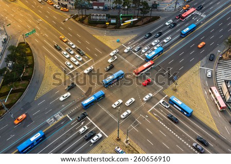 Rush hour traffic zips through an intersection in the Gangnam district of Seoul, South Korea. Royalty-Free Stock Photo #260656910