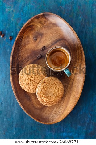 Coffee  in cup  on a wooden tray and cookies . Top view 