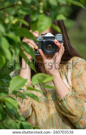 Girl with vintage retro camera. Hipster style.