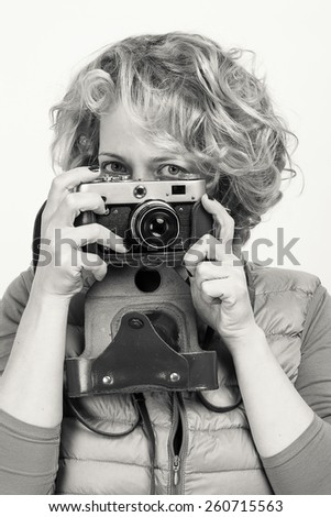 Girl with a vintage camera, black and white portrait