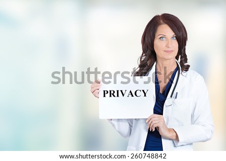 Female healthcare professional doctor scientist researcher pharmacist holding privacy sign isolated hospital windows background. Confidentiality patient care medical record information HIPAA concept

