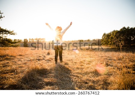 Freedom - This is a shot of a young woman wearing a hat enjoying the wide open spaces. Shot with a warm color tone.