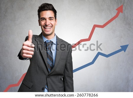 Man giving thumbs up in front of a positive diagram Royalty-Free Stock Photo #260778266