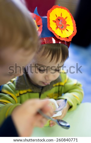 Little cute boy having birthday party at kindergarden