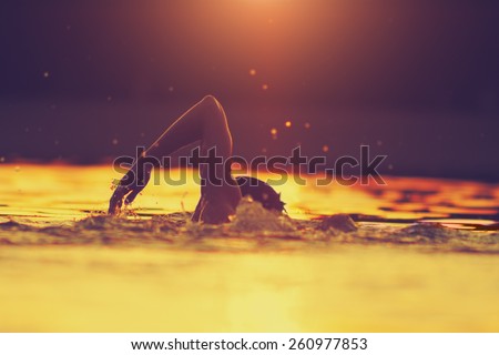 Swimming in sunset/sunrise with tropical colors. Royalty-Free Stock Photo #260977853