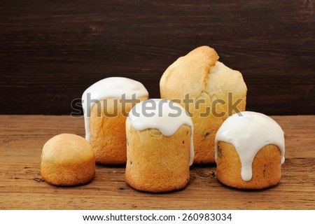 Kulichi, traditional Russian Easter cake with icing on wooden background
