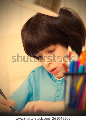 Boy doing homework, portrait. instagram image style