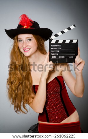 Woman in pirate costume with movie board