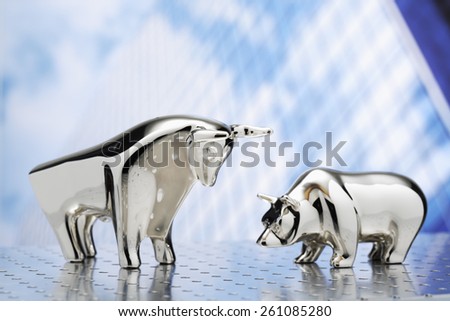 Bull and bear, high-rise building in the background Royalty-Free Stock Photo #261085280