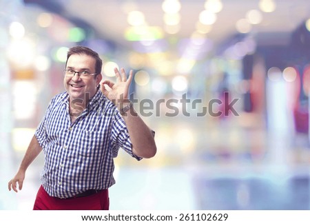 nerd man okay gesture in a shopping center