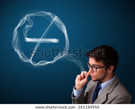 Handsome young man smoking unhealthy cigarette with no smoking sign