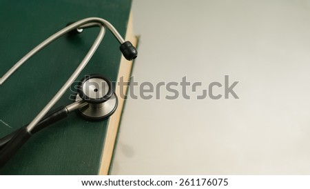 stethoscope and books on white background.
