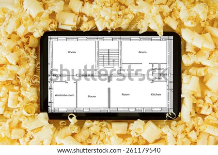 Planning of construction of the house. Joiner's works. Woodworking. Tablet, drawings and working tools on a wooden background.